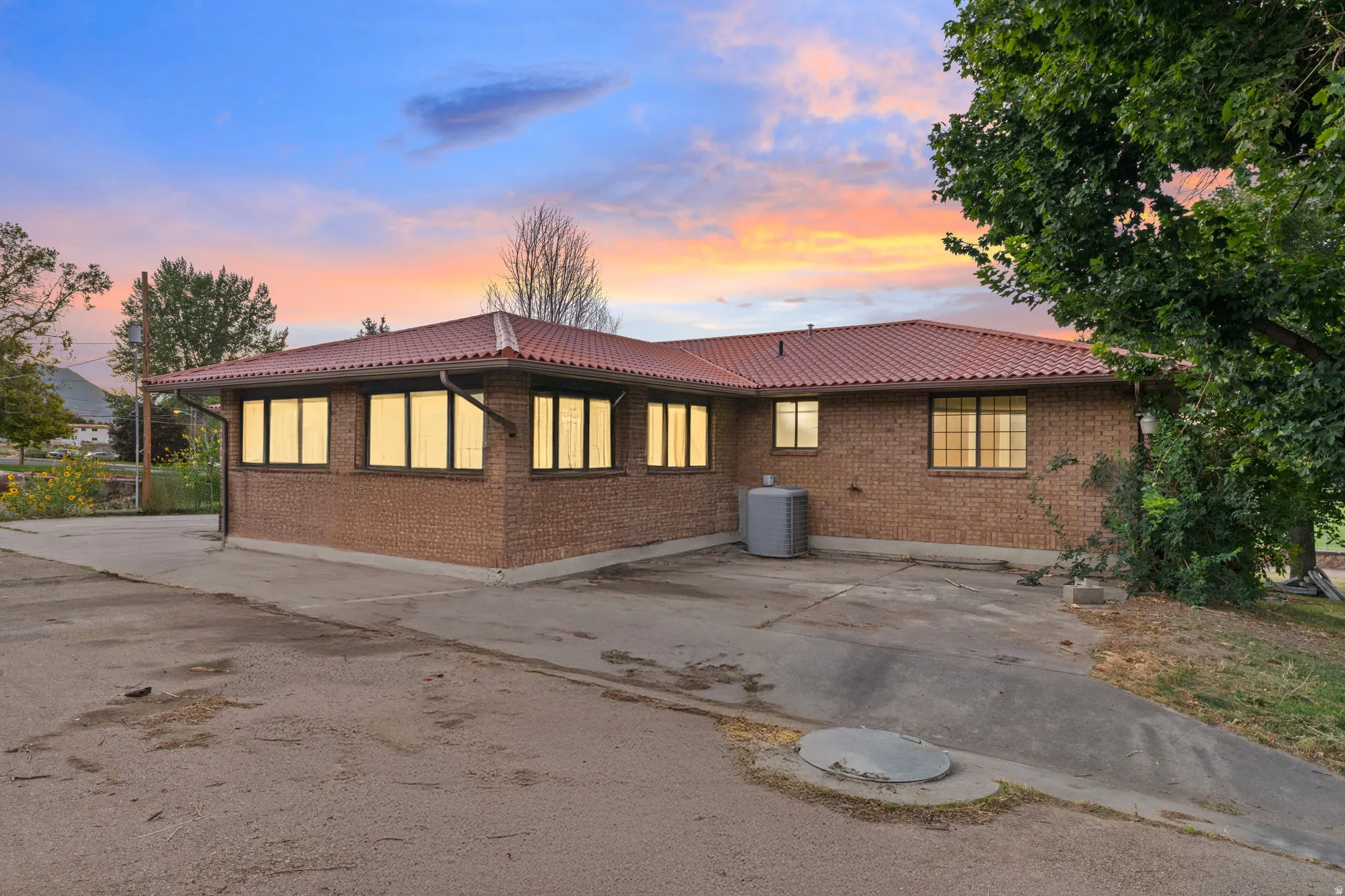 Brick exterior, red tile roof, and multiple windows