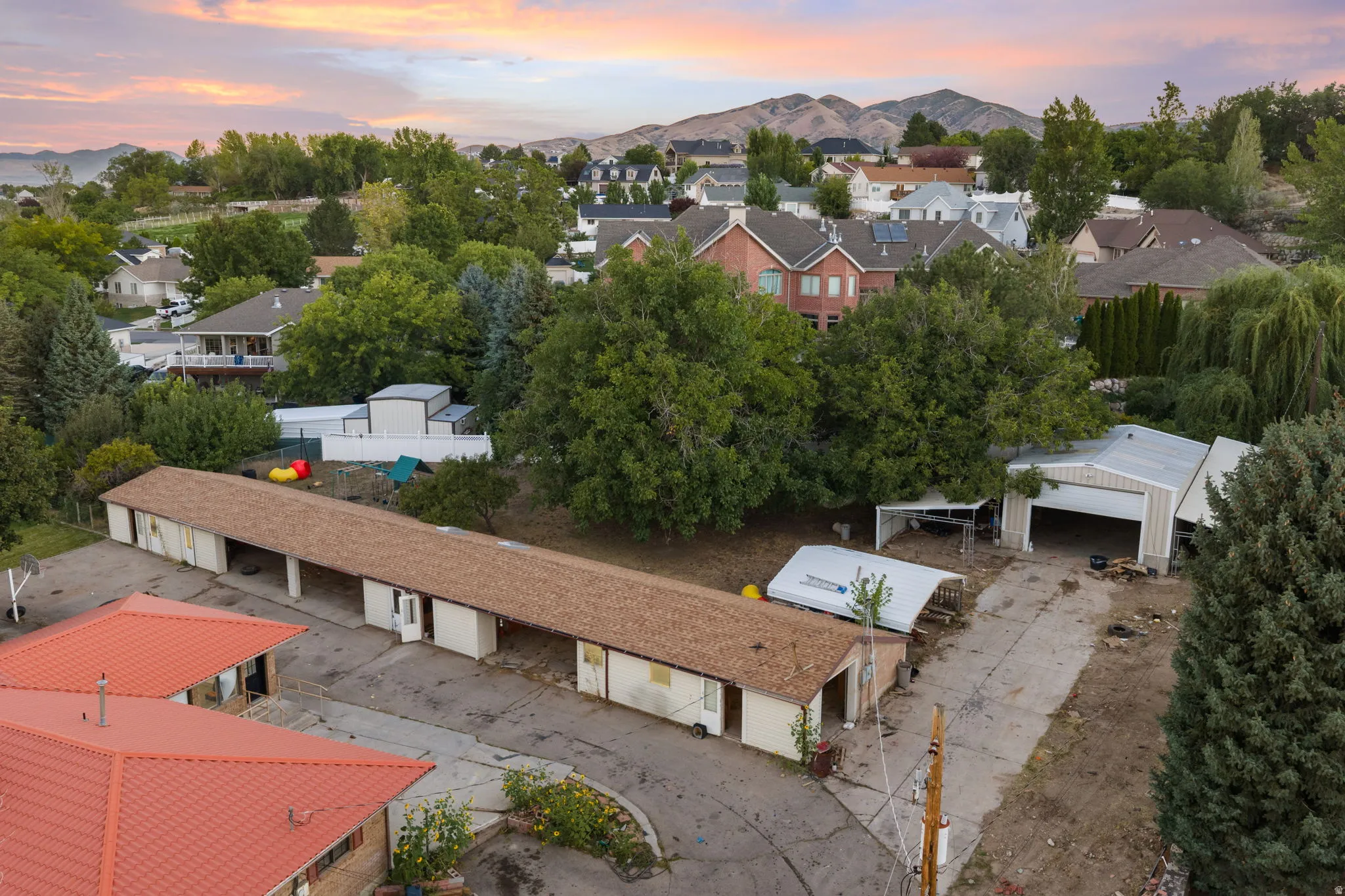 Extensive multi-bay storage building, additional covered parking structures, and an open-faced garage