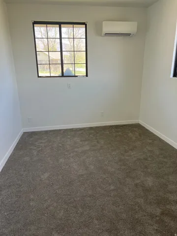 Wall-mounted heating and cooling unit