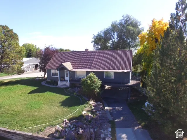 Gray exterior with a brown corrugated metal roof