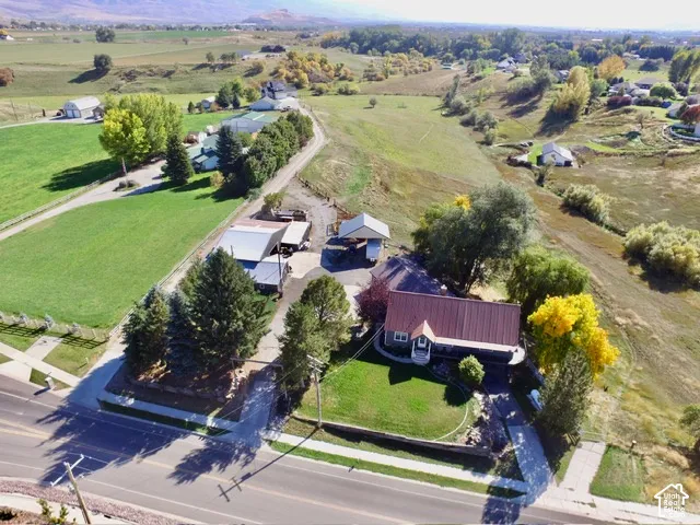 Red metal roof home with a paved driveway