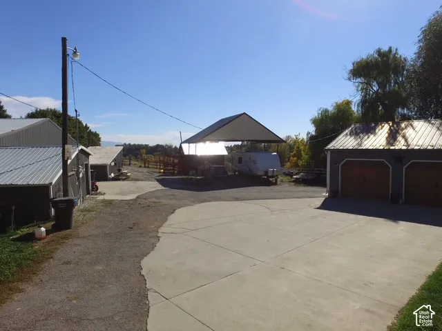 Concrete and gravel surfacing with multiple outbuildings featuring metal roofs