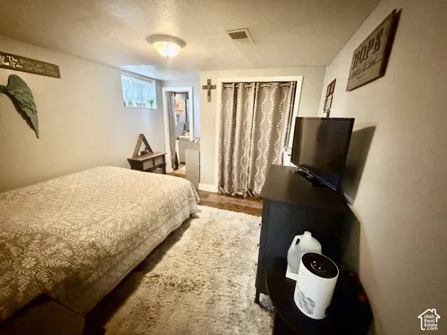Wood-finish flooring with a light-toned area rug