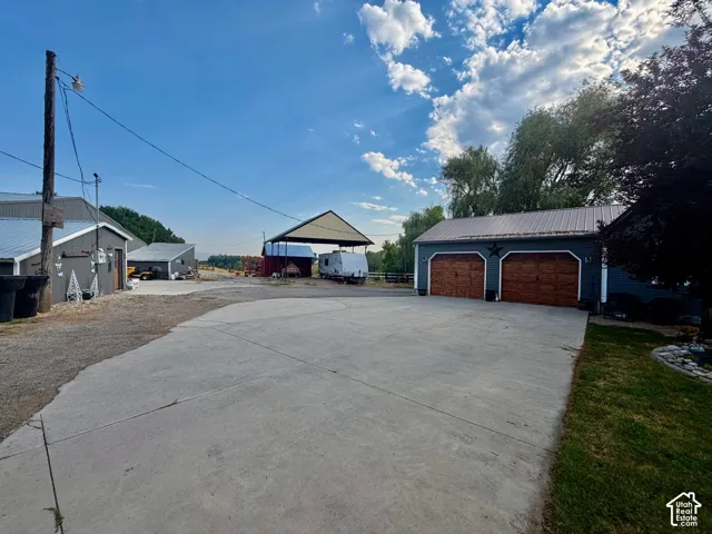 Detached garage with two wood-finish doors and metal roof
