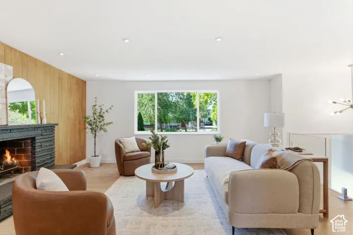 Light wood-finish flooring, recessed lighting, and a window with green outdoor scenery