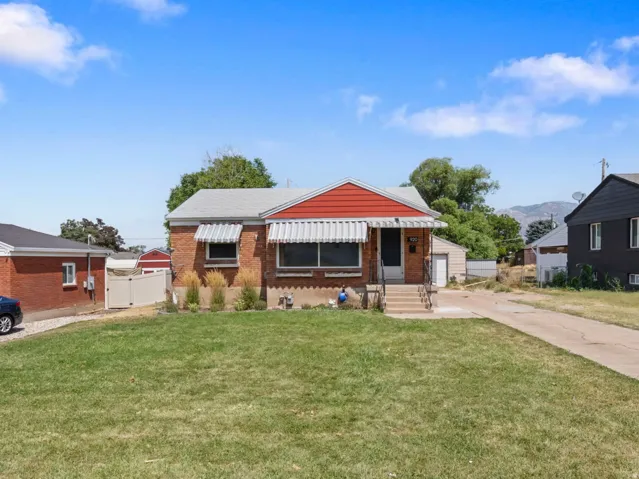 Brick exterior with a gabled roof and front awning