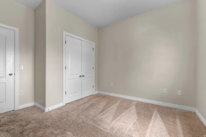 Neutral-toned walls with light brown carpeting