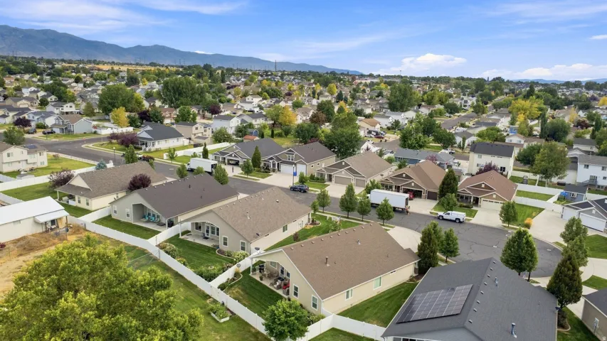 Neighborhood setting with mature trees and mountain backdrop