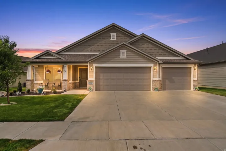 Single-story residence featuring a covered front porch, a two-car garage, and a concrete driveway