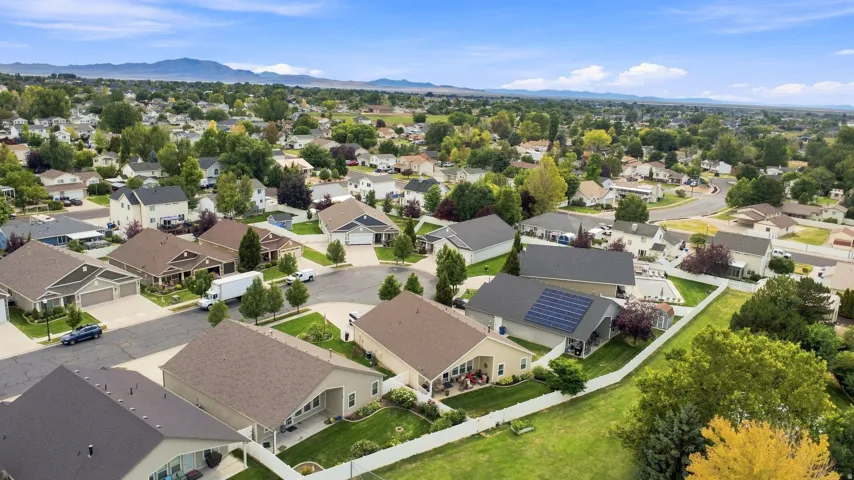 Residential neighborhood with established landscaping and mountain backdrop