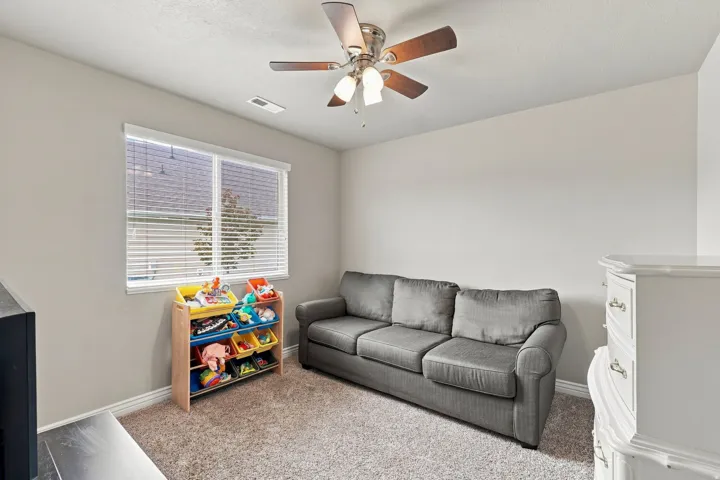 Recessed window with blinds, ceiling fan with integrated lighting, and neutral wall paint