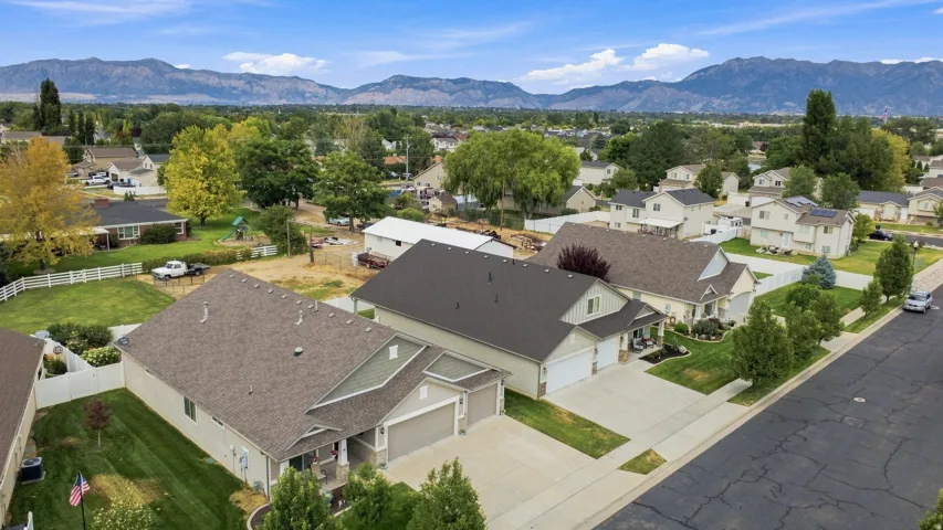 Aerial perspective showcasing a residential neighborhood with mountain scenery