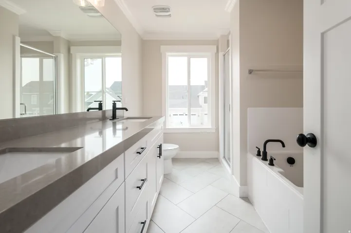 Dual vanity with integrated sinks and dark-finish fixtures