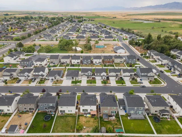 Aerial perspective of a developed residential community with uniform roofing and landscaping