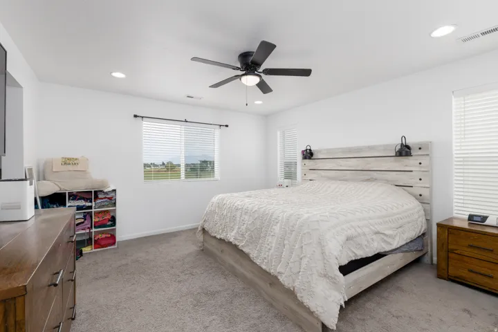 Recessed lighting, ceiling fan, window with blinds, and light gray carpet