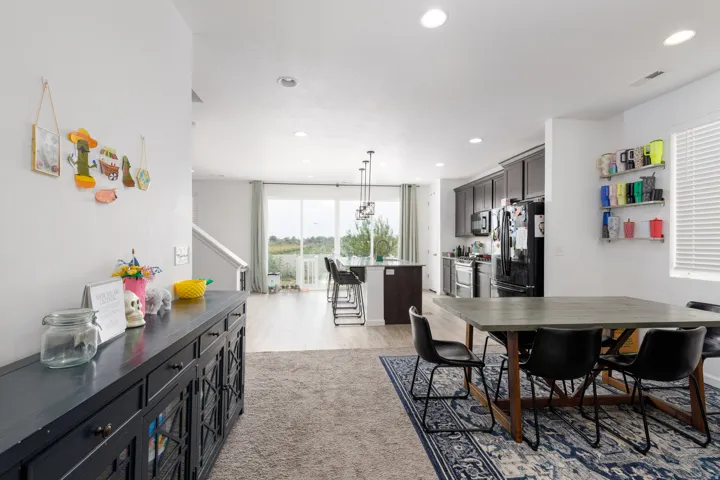 Open-concept living space with dark wood-finish cabinetry, recessed lighting, and wood-finish flooring