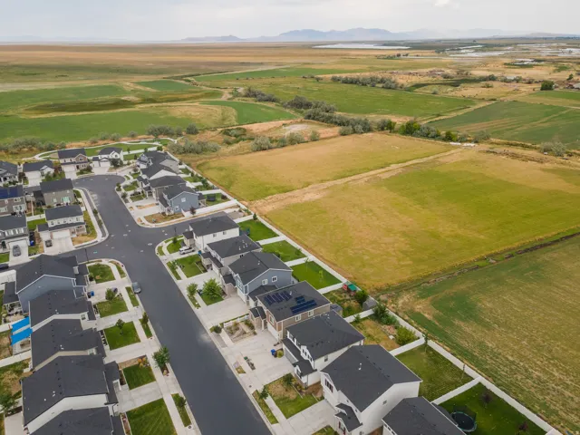 Residential community with single-family homes, paved streets, and manicured lawns