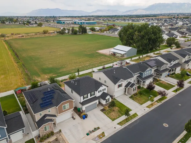 Modern residential community featuring new construction homes with clean architectural lines, dark asphalt roofing, and integrated two-car garages