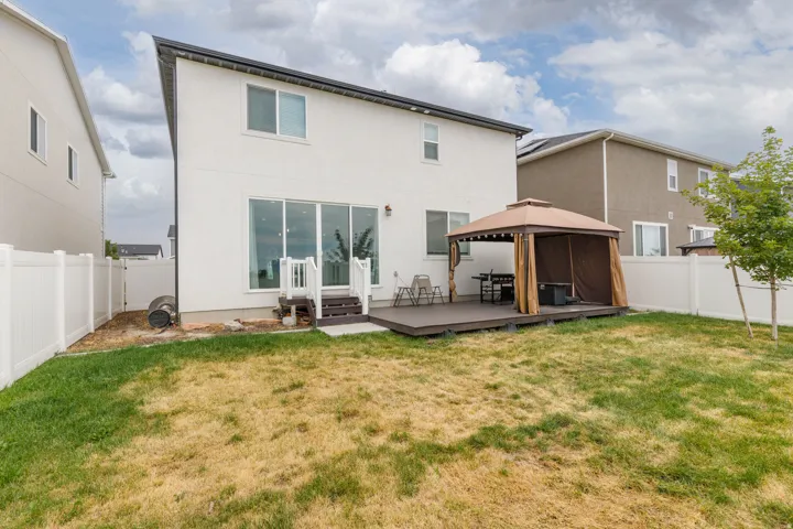 White stucco exterior with a dark trim roofline