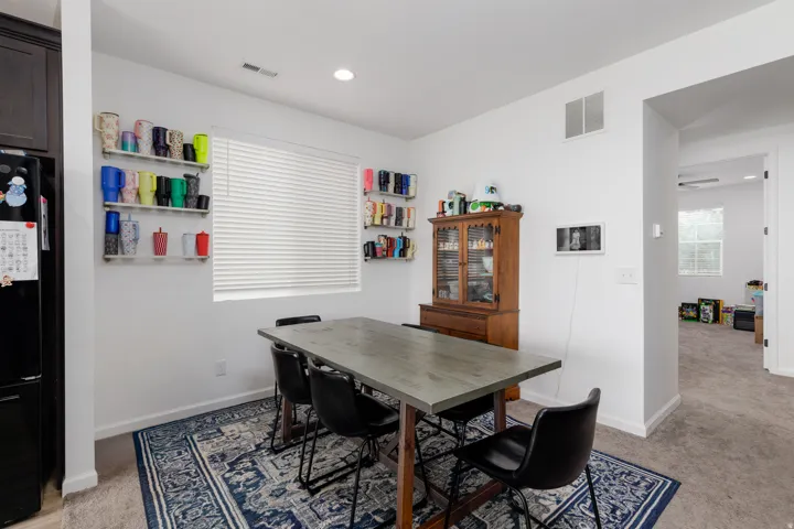 Recessed lighting, white walls, and wood-finish flooring