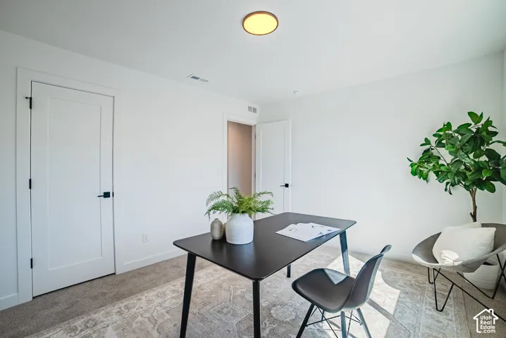 Recessed lighting, white interior walls, white paneled doors, and dark hardware