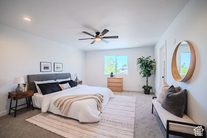 Expansive bedroom featuring recessed lighting, a ceiling fan, and carpeted flooring
