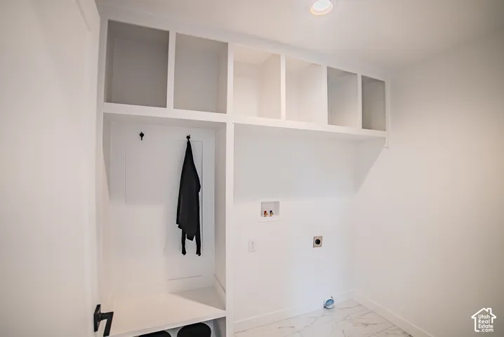 Built-in white cabinetry, integrated open shelving, recessed lighting, and tile flooring
