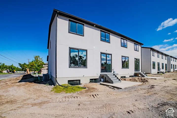 Modern multi-story exterior with white stucco finish