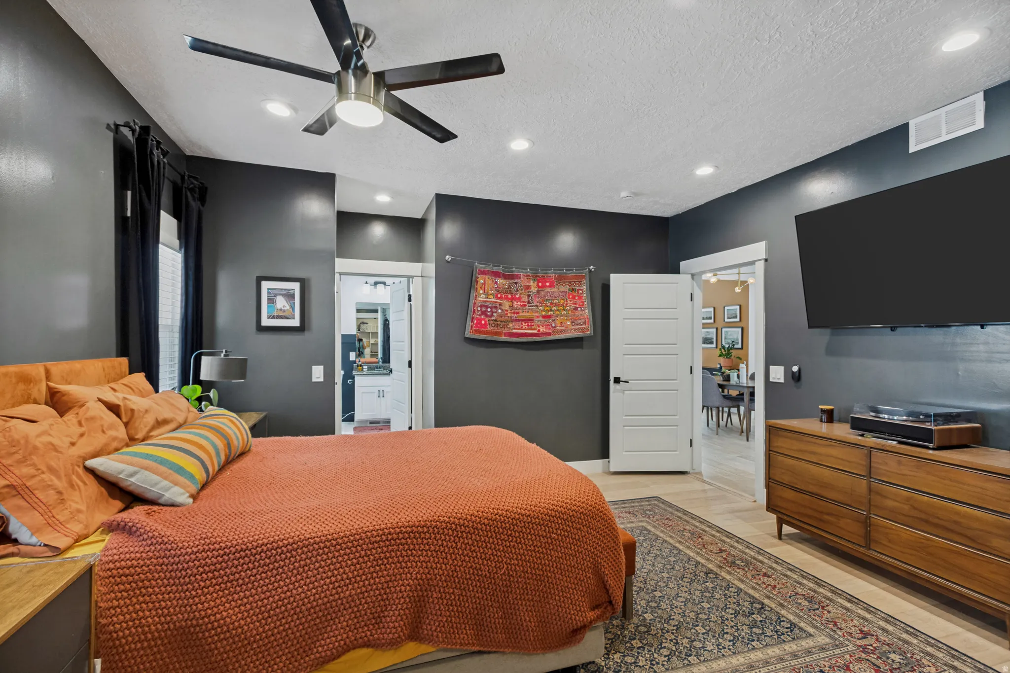 Primary Bedroom Suite with Soft-Close Ceiling Fan, Recessed Lighting, and Wood-Finish Dresser