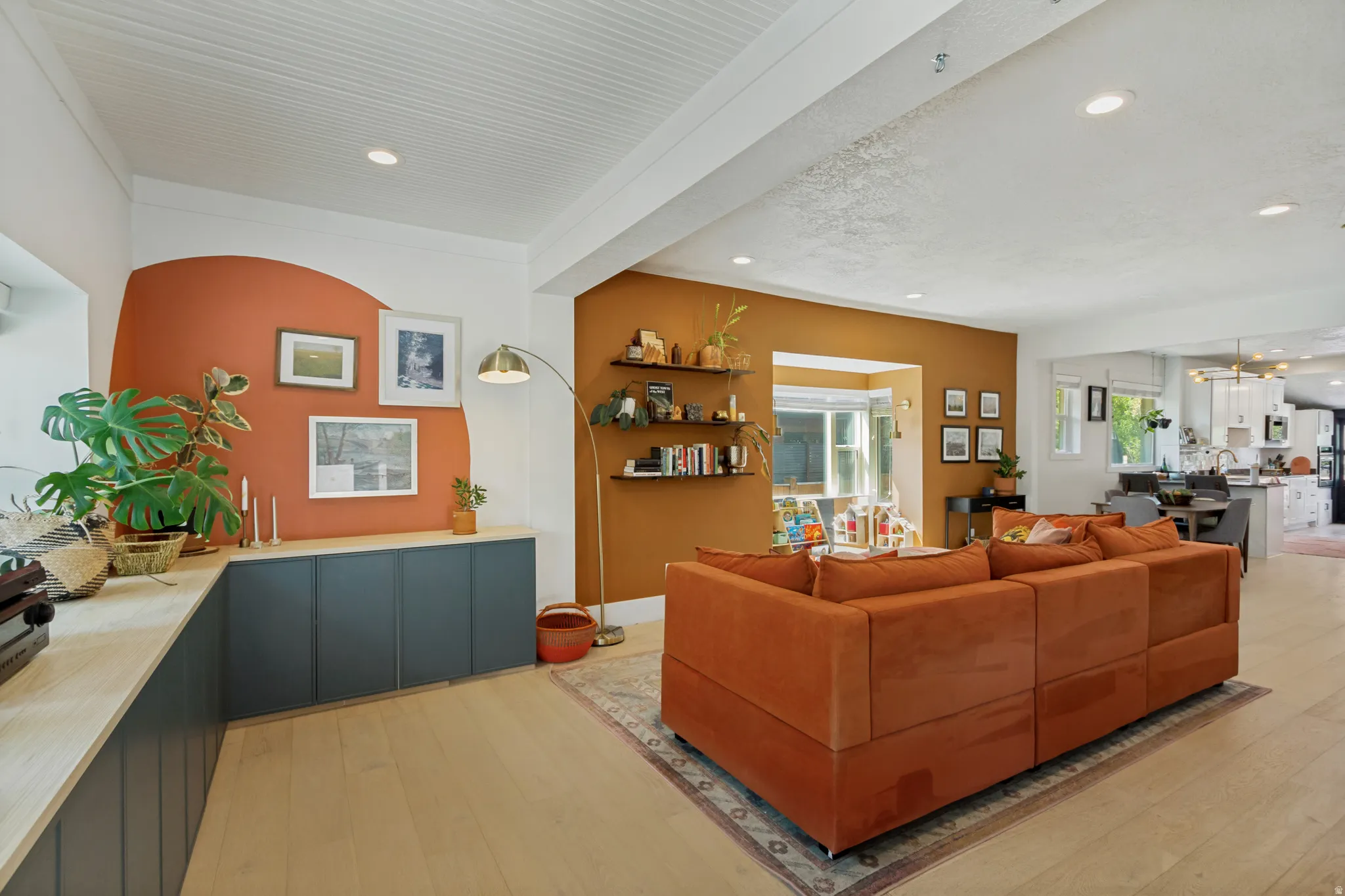Recessed lighting, wood-finish flooring, custom built-in cabinetry, painted accent walls, and open-concept design