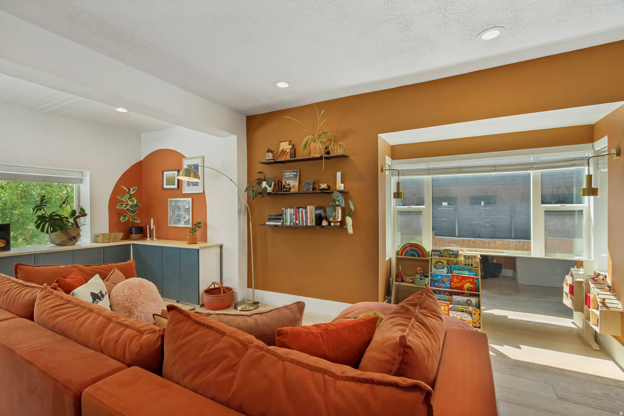 Recessed lighting, built-in cabinetry, floating shelves, and window treatments