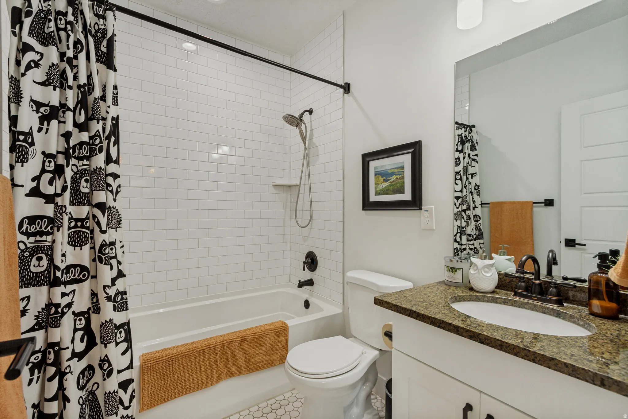 White subway tile shower surround with integrated shelf, built-in bathtub, and dark bronze fixtures