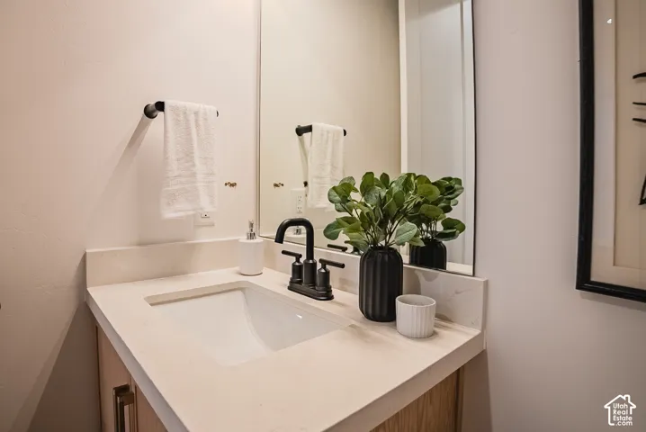 White rectangular undermount sink with a matte black faucet