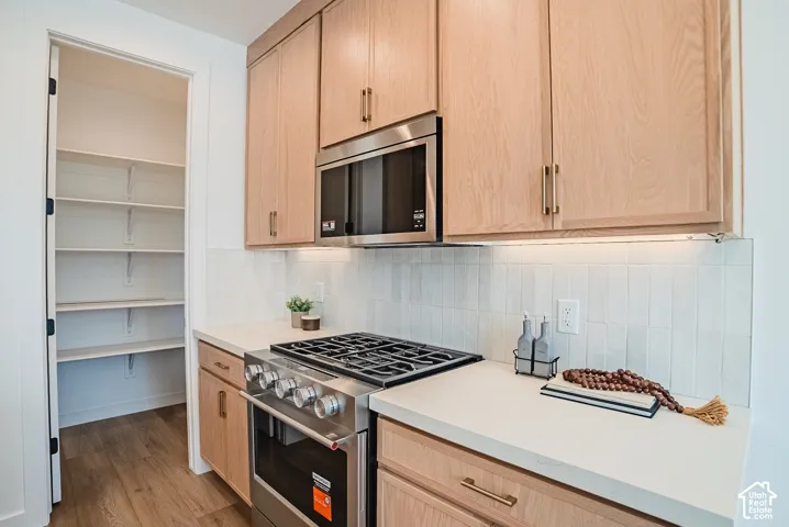 Light wood-finish cabinetry with gold-tone hardware