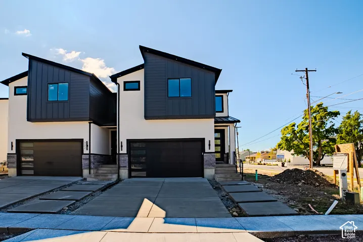 Modern architectural design featuring prominent black-framed windows and a dark-toned metal roof