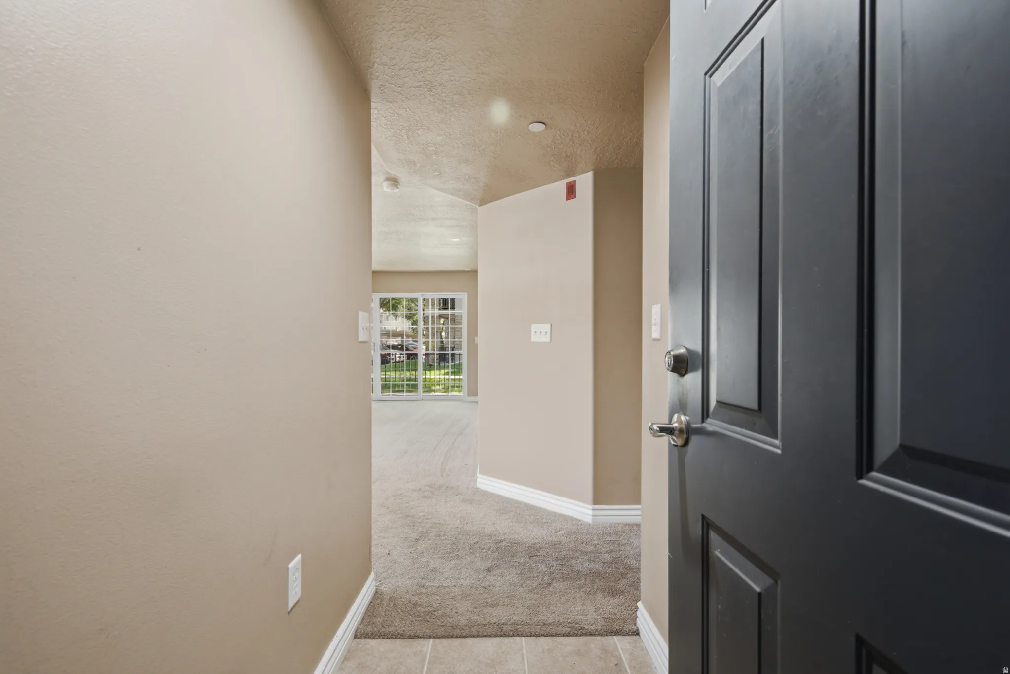 Entryway featuring tile flooring, neutral wall tones, and a paneled entry door with brushed nickel hardware