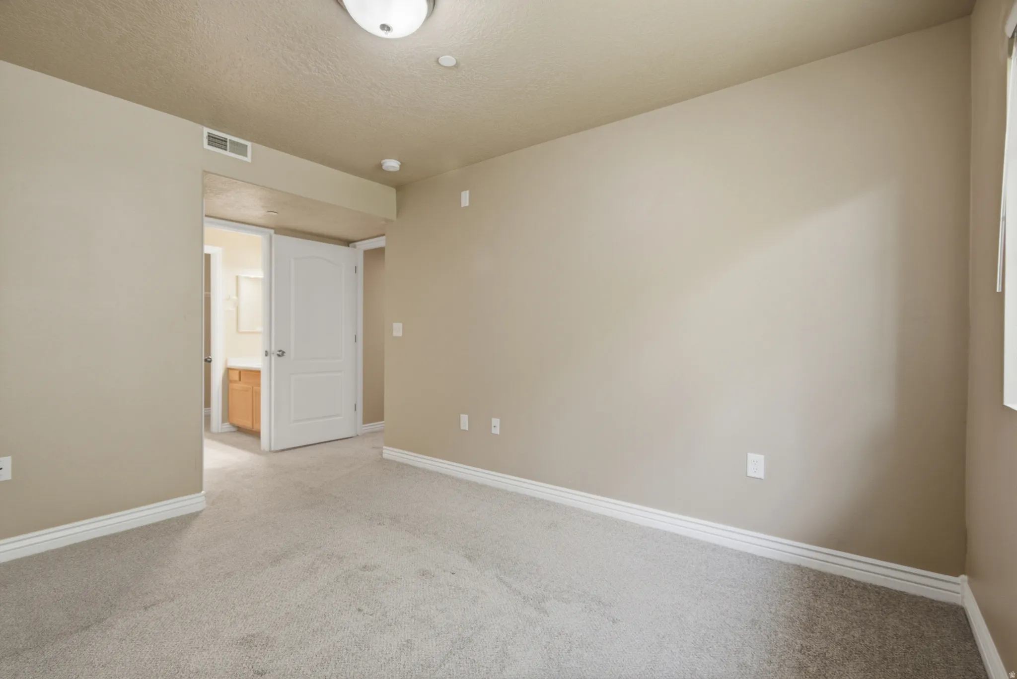 Neutral-toned carpeting and walls