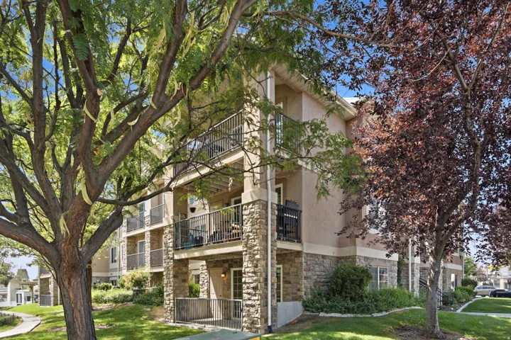 Multi-story exterior featuring a stucco facade with stone accents