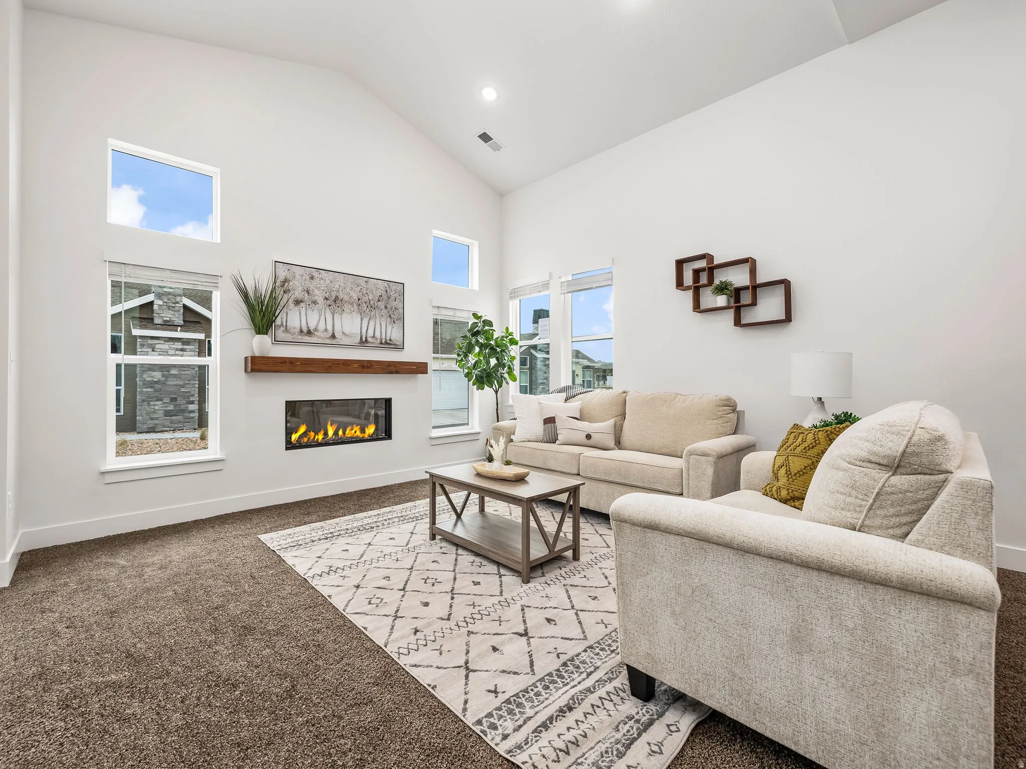 Living room with cozy fireplace and vaulted ceilings