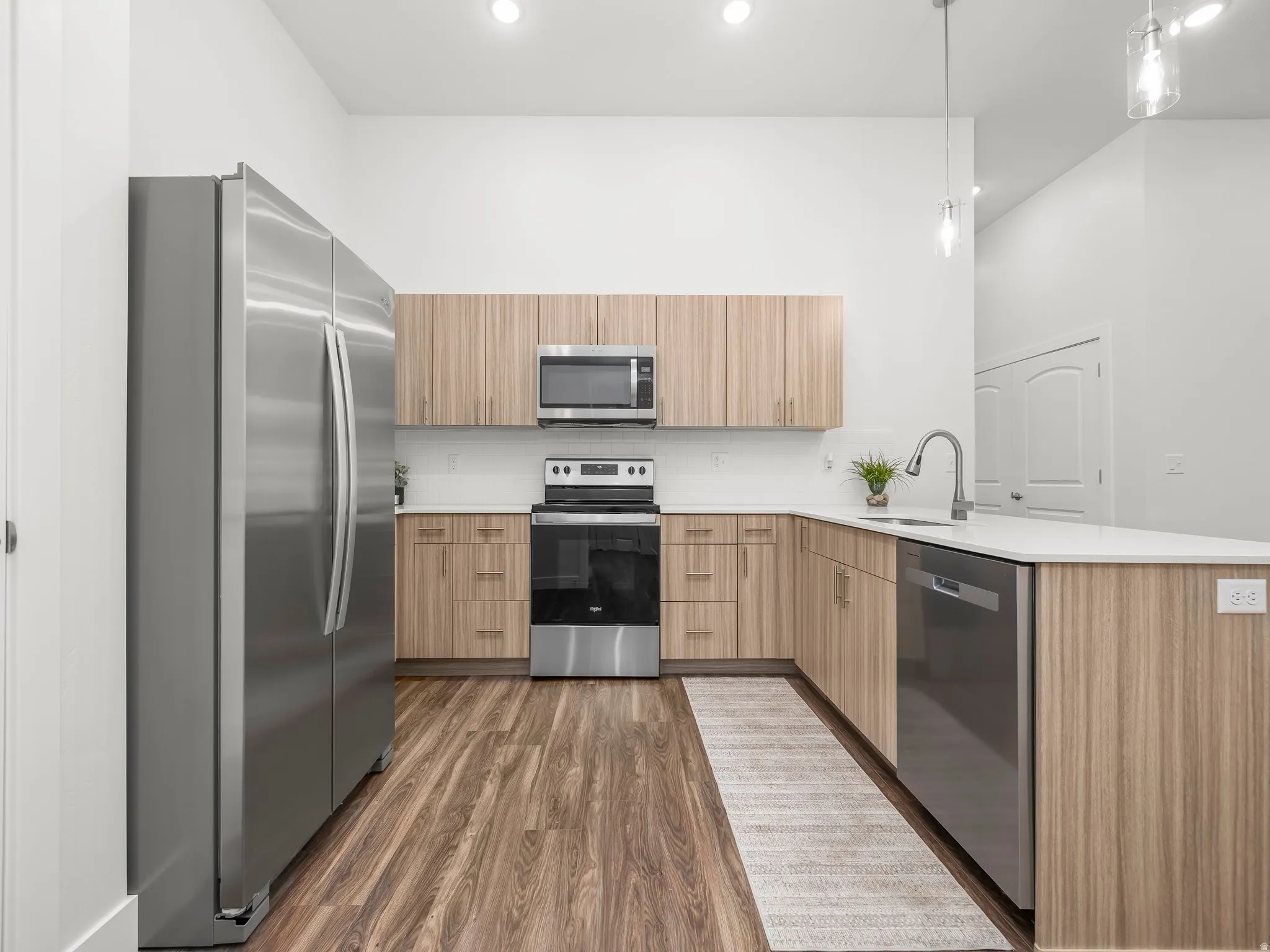 Kitchen with stainless steel appliances and quartz counters. *Fridge not included*