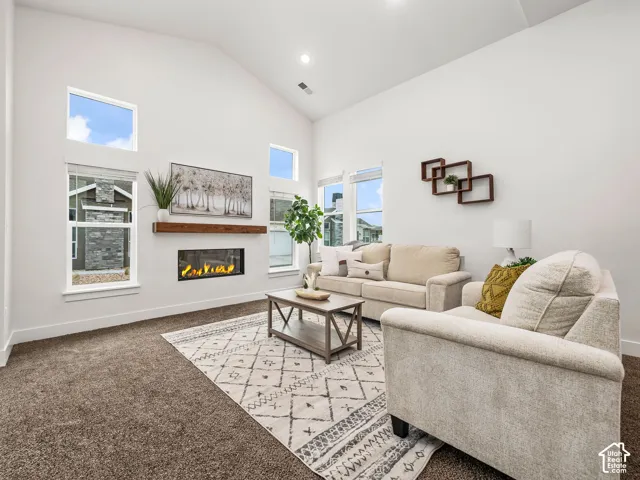 Living room with cozy fireplace and vaulted ceilings