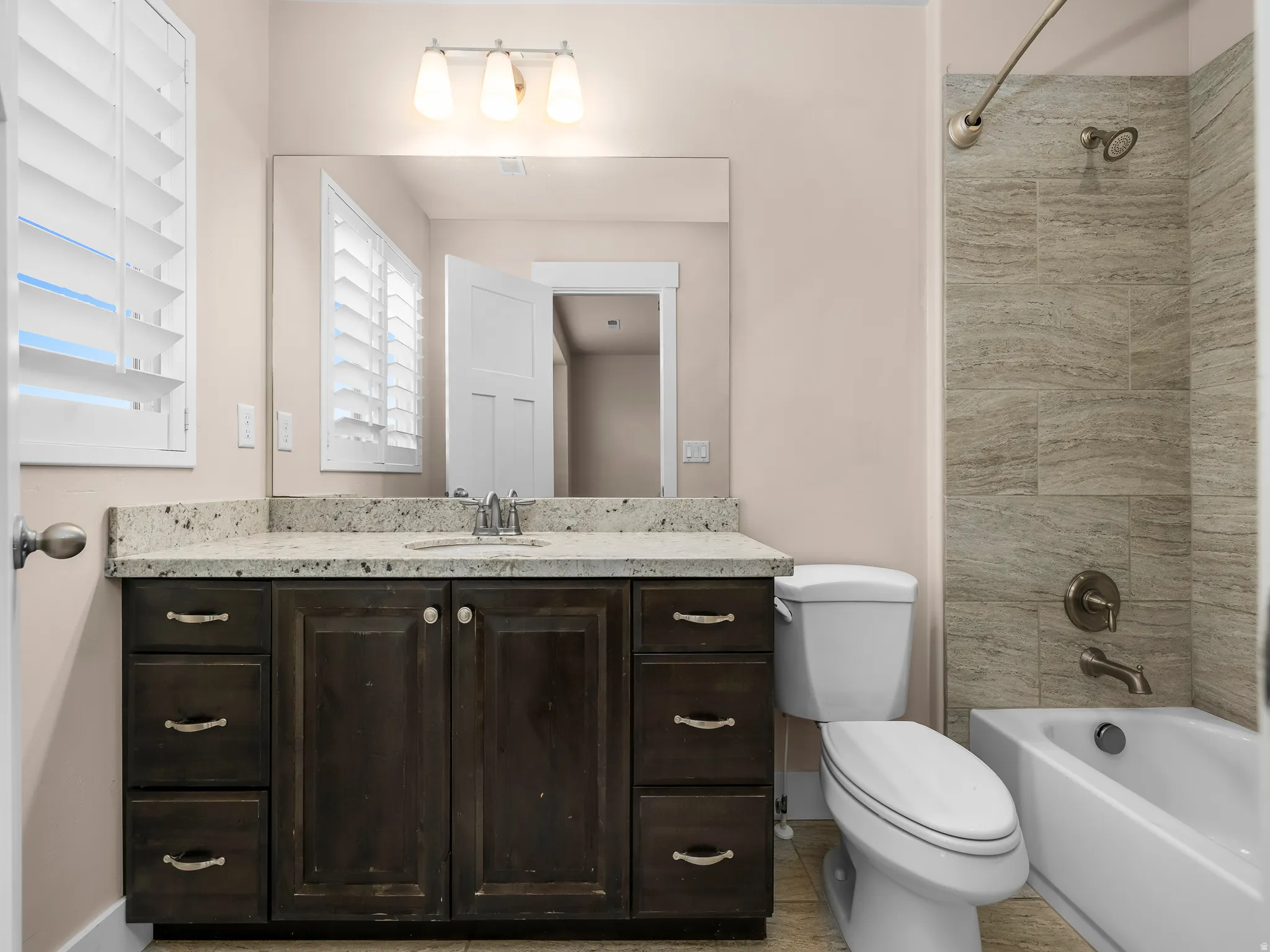 Granite countertop vanity with wood-finish cabinetry