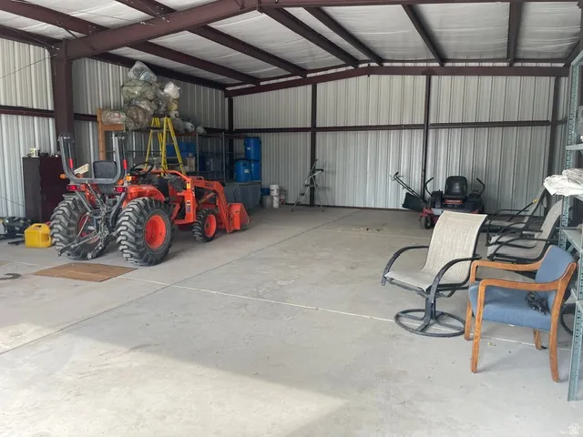 Spacious metal structure with a concrete floor, exposed steel beams, and corrugated metal walls
