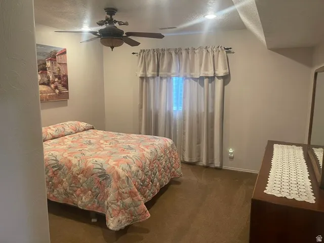 Recessed lighting, ceiling fan, and carpeted flooring