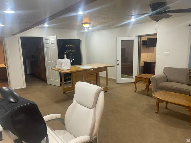 Recessed lighting, wood-finish beam, ceiling fan, carpeted flooring, and French doors