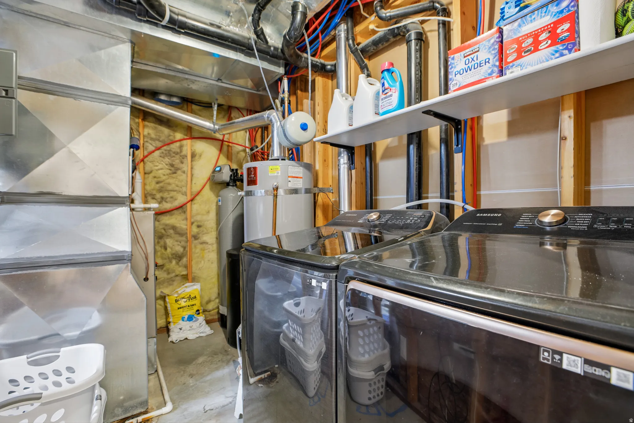 Utility area with a water heater, water softener, and ductwork