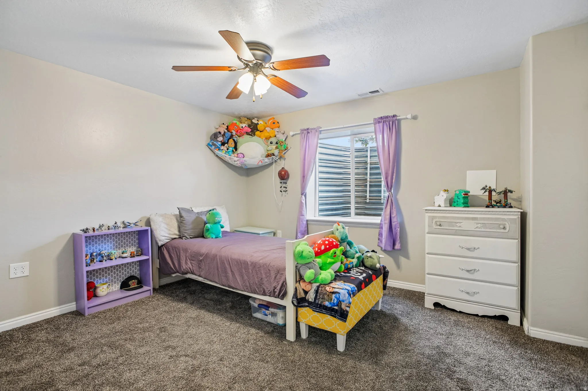 Textured gray carpeting with light gray wall paint, white trim, and a ceiling fan with integrated lighting