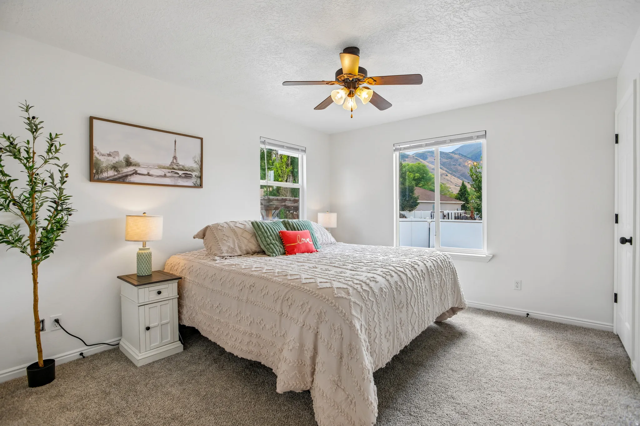Wall-to-wall carpeting, ceiling fan with integrated lighting, and white trim