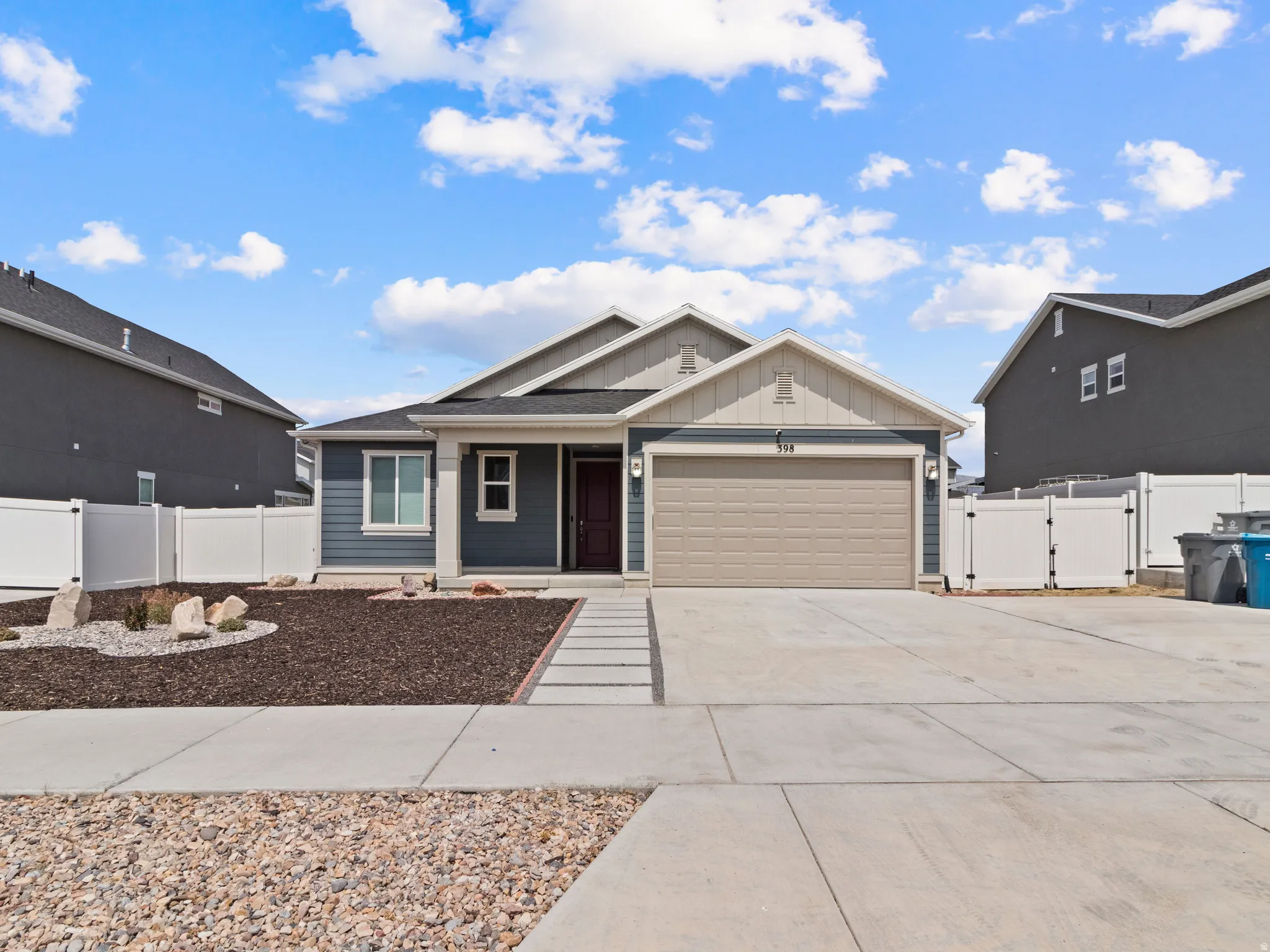 Contemporary exterior siding, attached two-car garage, concrete driveway, and front walk