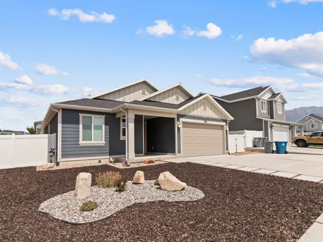 Contemporary exterior with dark siding, light trim, and an attached garage